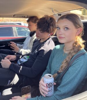 Dr. Ryan Noseck’s three children seated together in a car during a family trip