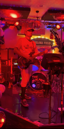 Dr. Ryan Noseck playing bass onstage with The Molars